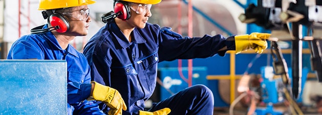 Industrial Workers Using Pneumatic Tools